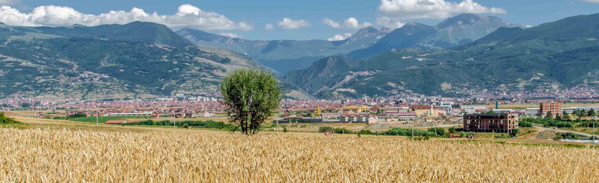 View across the fields of Kosovo to a town in the distance