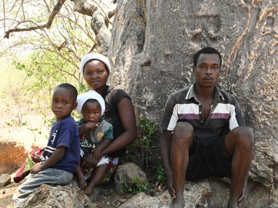 A family sitting under a tree in Zimbabwe