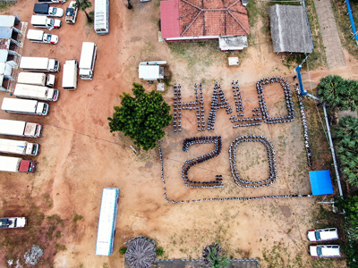 HALO Staff stand in formation to display "HALO 20" from a birds-eye view to mark 20 years of HALO in Sri Lanka