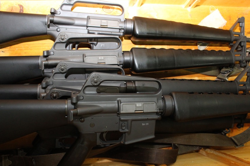 guns sit in a yellow case