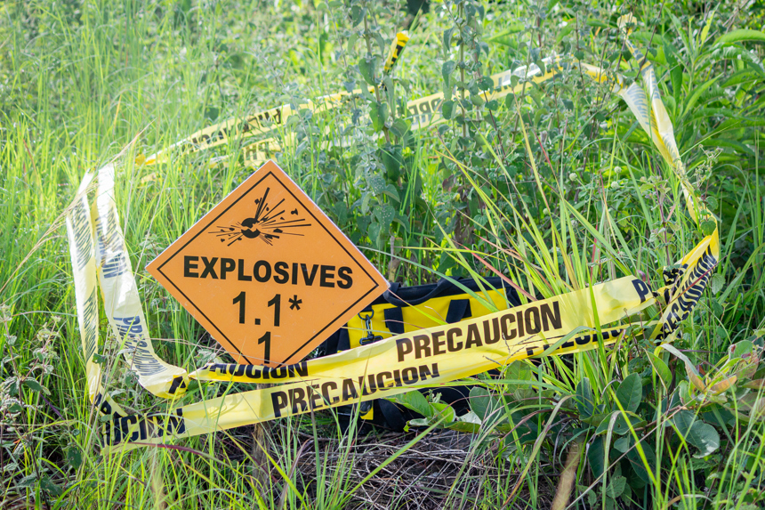 Explosives warning sign on a field in Honduras