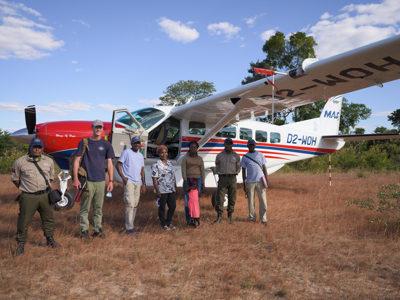 In Cuando Cubango Province, a group of HALO staff stand in front of a plane from the Mission Aviation Fellowship.