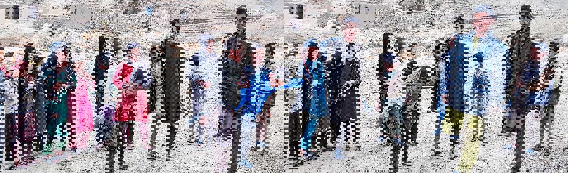 Children stand together smiling in a  district of Samangan province