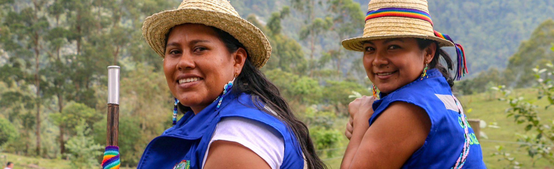 Two women from the Kwet Wala Indigenous Reserve look back with a smile