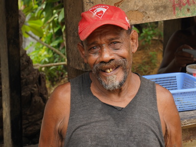 Timothy Rekoel, a father of six stands in his backyard and smiles at the camera