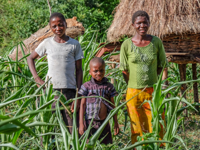 Sadzurai Kamoyo, and her two sons pose outside