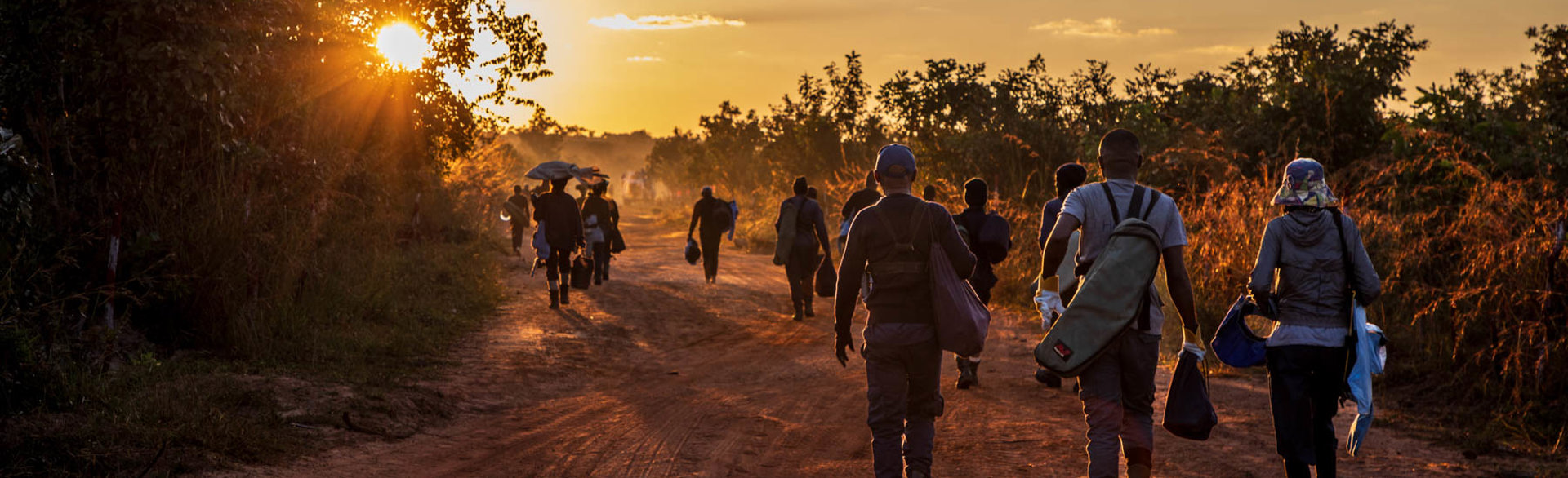 HALO deminers walk home after work in Lusserei, Angola