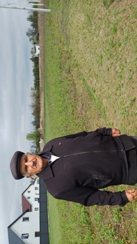 Ivan Ivanovych stands in front of his vegetable garden after HALO landmine clearance operations