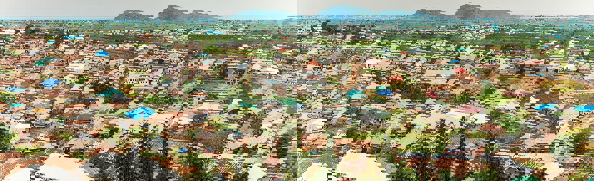 Nigerian homes with plains and hills behind