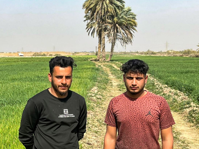 Mohammed Wayed and his cousin Ahmed stand on their farm