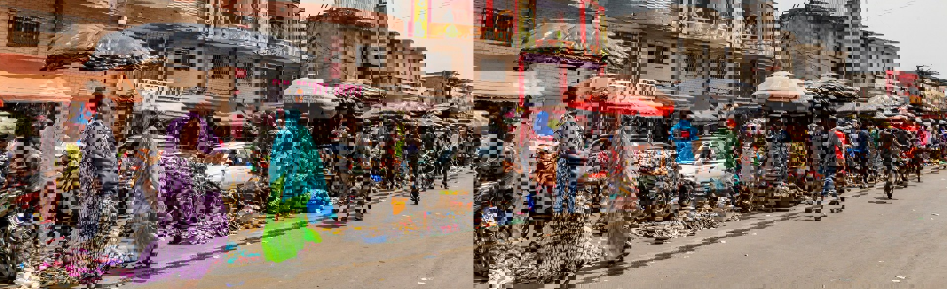 People walking along a street market in Cote d'Ivoire