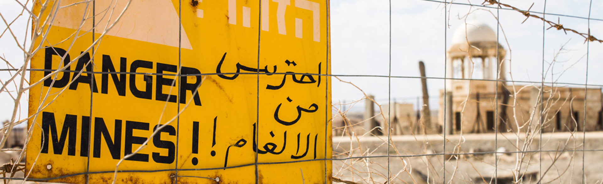 A danger mines sign on a fence outside the site of the Baptism of Christ