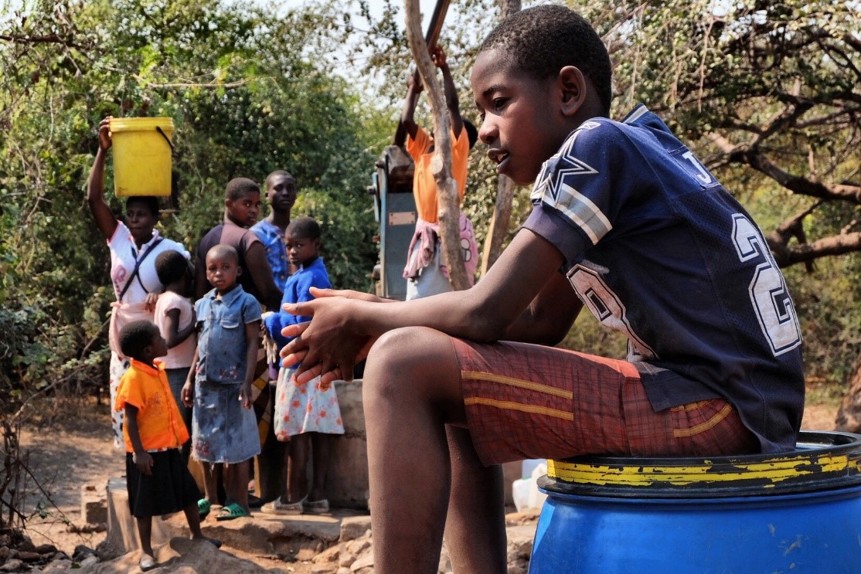 11 year old Maphioss collects water from a borehole in Zimbabwe