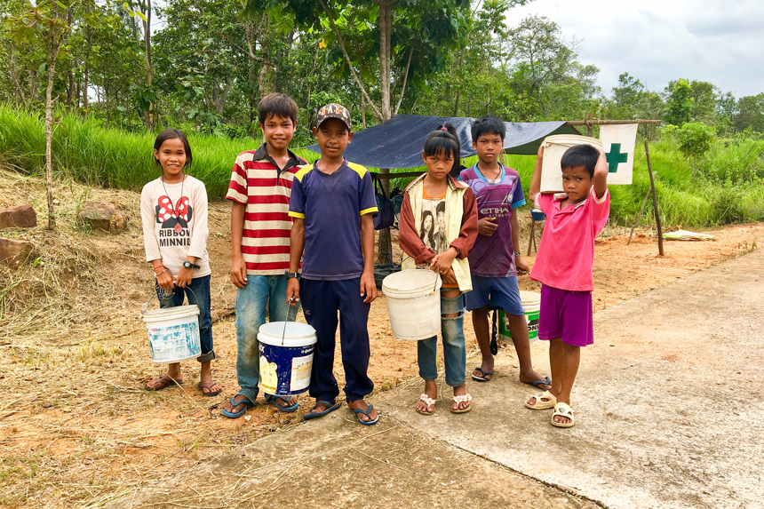 Children hold buckets for mushroom foraging in a village in Cambodia